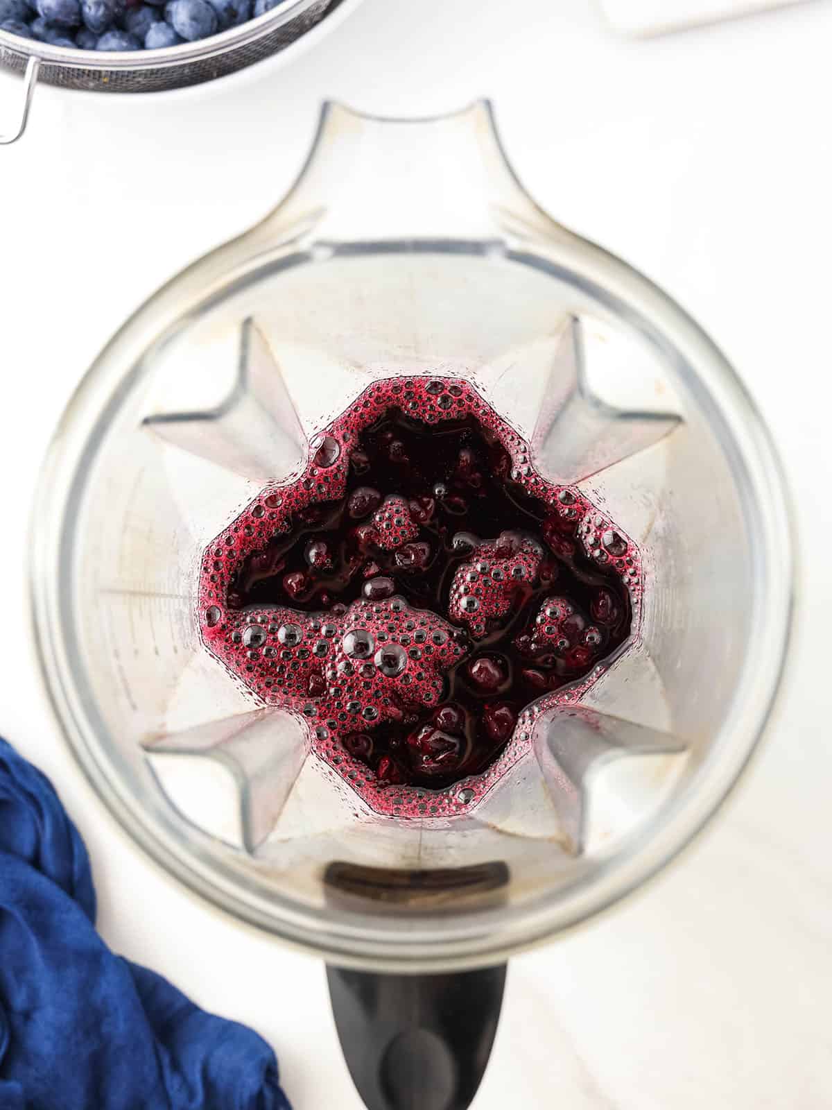 Blueberry mixture in a blender, top view. 