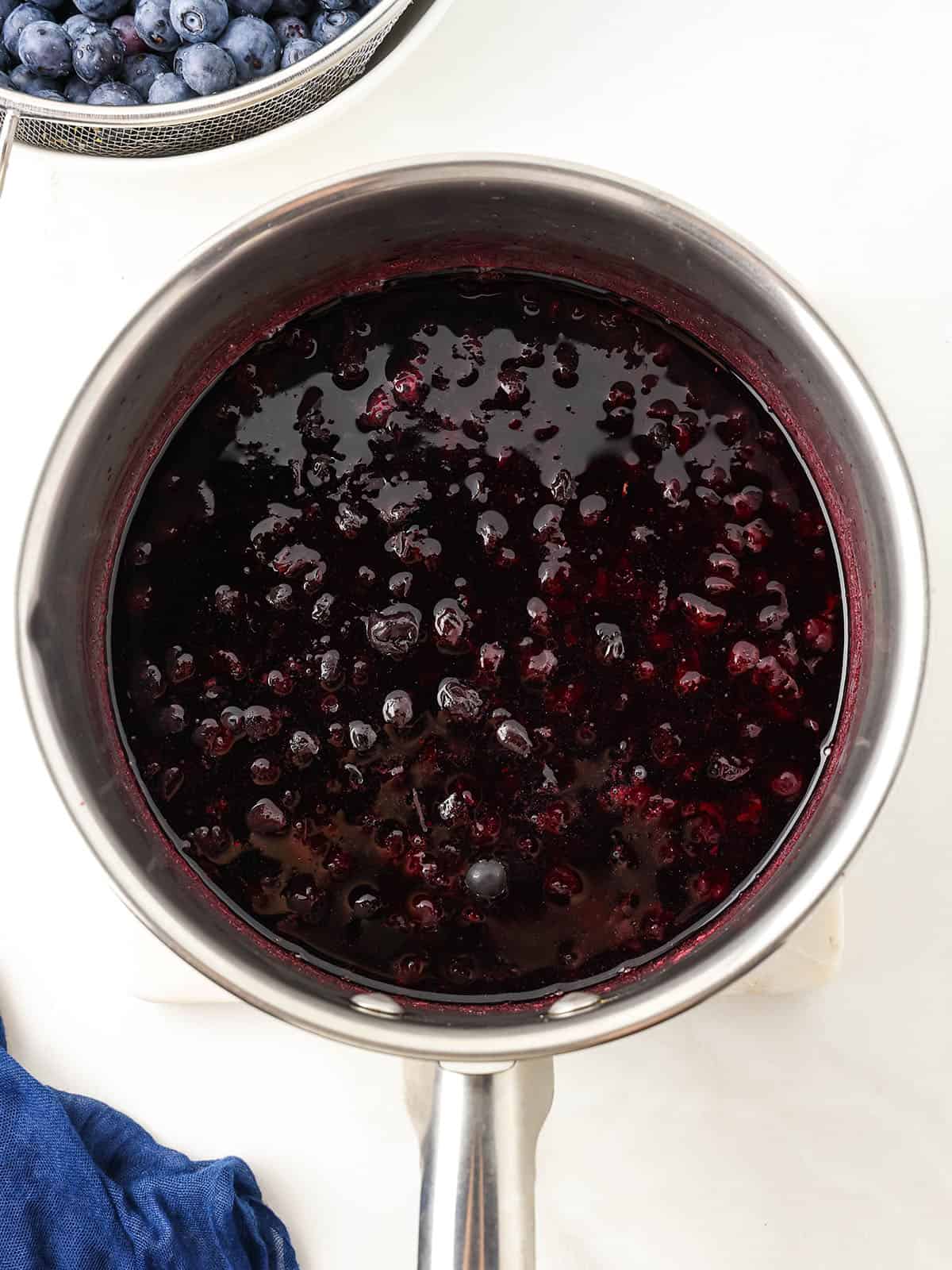 Blueberry puree ingredients in a pot, top view. 