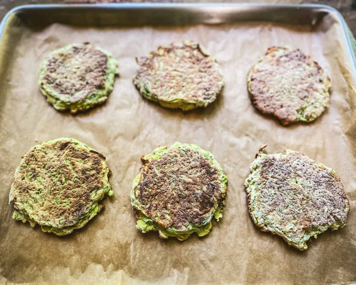 Zucchini pancakes frozen in one layer on a pan. 