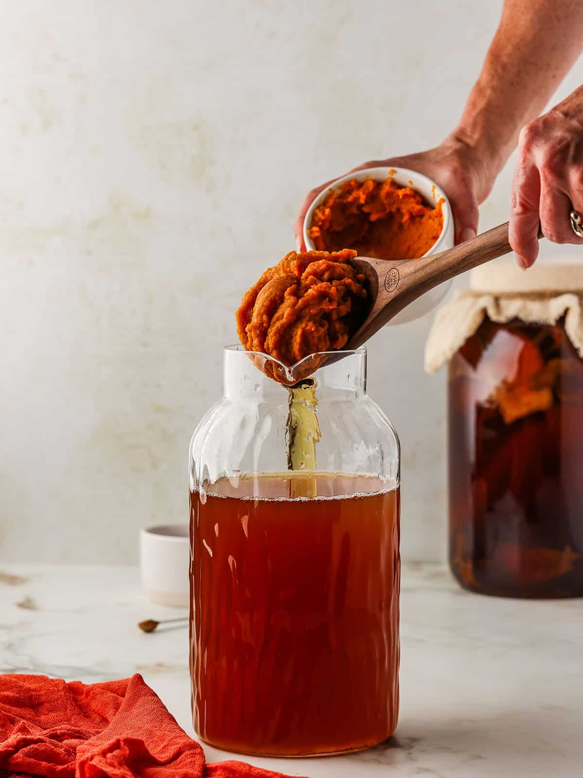 Pumpkin puree being spooned into a jar. 