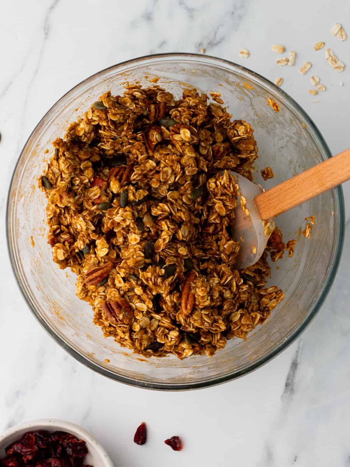 Combined granola mixture in a mixing bowl, top view. 